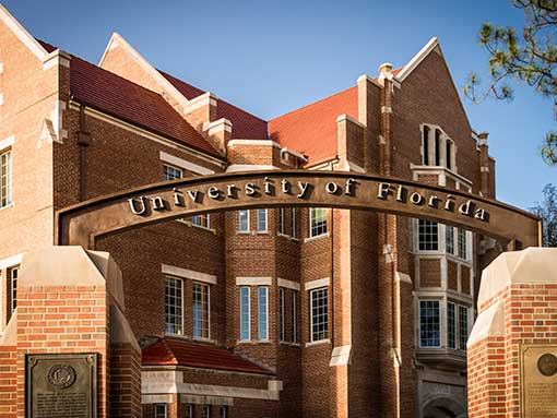 UF campus entrance archway with brick buildings in the background